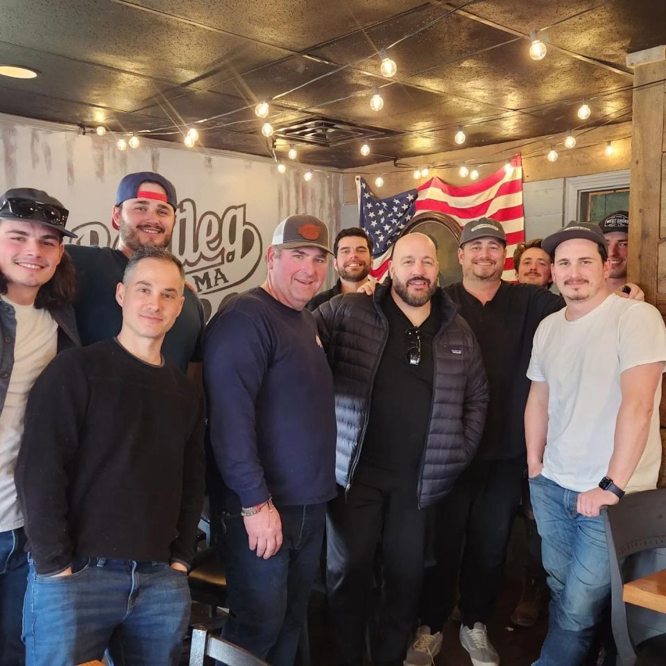 Bootleg BBQ owner Fred Melnyk takes a photo with friends and members of the Kinnane Brothers Production Company and actor Kevin James, who visited the Westport eatery on Thursday, Feb. 16, 2023.