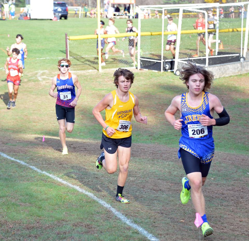 Smithsburg's Michael Wynkoop (306) leads Boonsboro's Jakob Davidson (31) in the first mile of the Class 1A boys race. Wynkoop finished fifth in 17:18.22 and Davidson was sixth in 17:26.49.