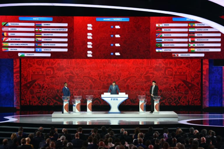 (L-R) Samuel Eto'o, Jerome Valcke and Rinat Dasaev hold the preliminary draw for the Confederation of African Football (CAF) zone for the 2018 World Cup qualifiers at the Konstantin Palace in Saint Petersburg on July 25, 2015