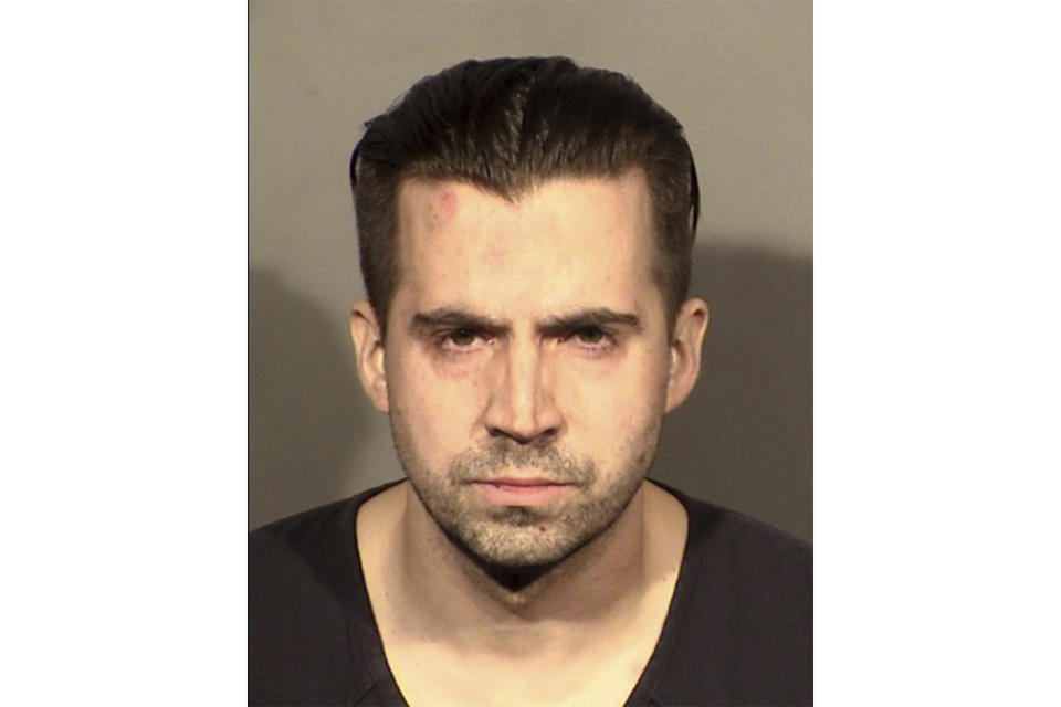 FILE - This booking photo provided by the Las Vegas Police Department shows Officer Caleb Rogers in Las Vegas, Feb. 27, 2022. A jury trial is set to begin Monday, July 10, 2023, in a federal case accusing the former Las Vegas police officer in three casino heists over a four-month span that netted more than $85,000. (Las Vegas Police Department via AP, File)