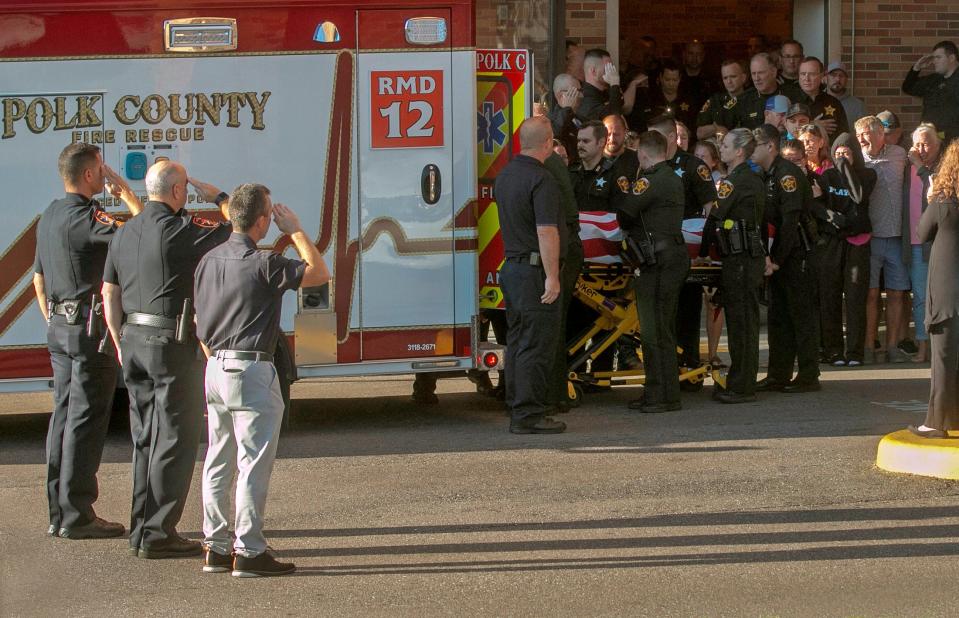 Polk County Sheriff's Deputy Blane Lane, 21, is placed in an ambulance at Lakeland Regional Health Medical Center on Tuesday as law officials and family mourn. Lane was killed early Tuesday morning while serving a warrant in Polk City. October 4, 2022.