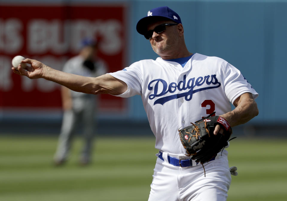 FILE - Former Los Angeles Dodger Steve Sax throws after fielding a ball during batting practice before an old-timers baseball game in Los Angeles, Saturday, June 10, 2017. Former Los Angeles Dodgers player Steve Sax has issued a statement saying that his 33-year-old son, Capt. John J. Sax, who had always dreamed of being a pilot was among five U.S. Marines killed during a training flight crash earlier this week in the California desert. (AP Photo/Chris Carlson, File)