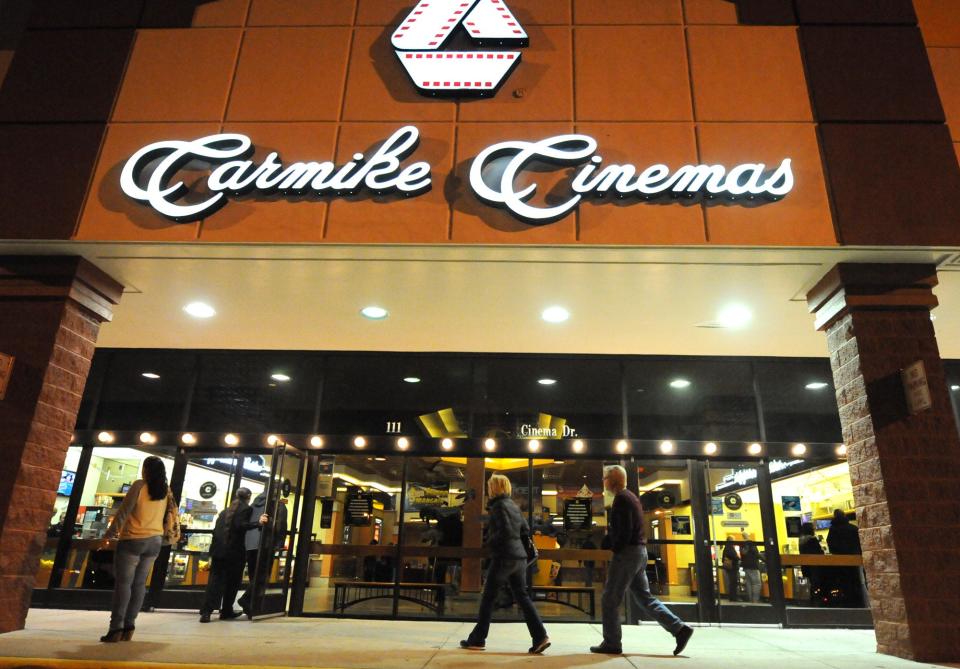 People walk into the movie theatre at Carmike Cinema 16 in 2013. AMC purchased Carmike in 2016.