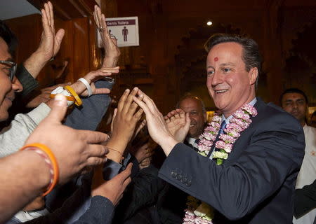 British Prime Minister and Conservative Party Leader David Cameron greets worshippers during a visit to the Neasden Hindu Temple in London on May 2, 2015, ahead of a general election in Britain on May 7, 2015. REUTERS/Niklas Halle'n/Pool