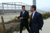 Attorney General of California Xavier Becerra accompanied by San Diego City Councilmember David Alvarez walks along the U.S.-Mexico border at the Pacific Ocean after announcing a lawsuit against the Trump Administration over its plans to begin construction of border wall in San Diego and Imperial Counties, in San Diego, California, U.S., September 20, 2017. REUTERS/Mike Blake