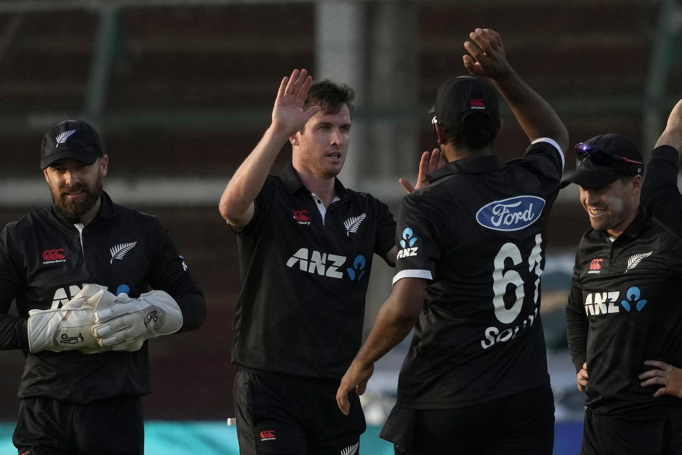 New Zealand's Adam Milne, center, celebrates with teammates after the his dismissal of Pakistan's Imam-ul-Haq during the third one-day international cricket match between Pakistan and New Zealand, in Karachi, Pakistan, Wednesday, May 3, 2023. (AP Photo/Fareed Khan)