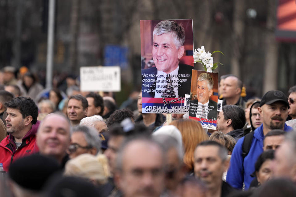 Protesters carry a picture of former Serbian Prime Minister Zoran Djindjic during a demonstration downtown Belgrade, Serbia, Saturday, Dec. 30, 2023. Thousands of people gathered to protest what election observers said were widespread vote irregularities during a recent general election. (AP Photo/Darko Vojinovic)