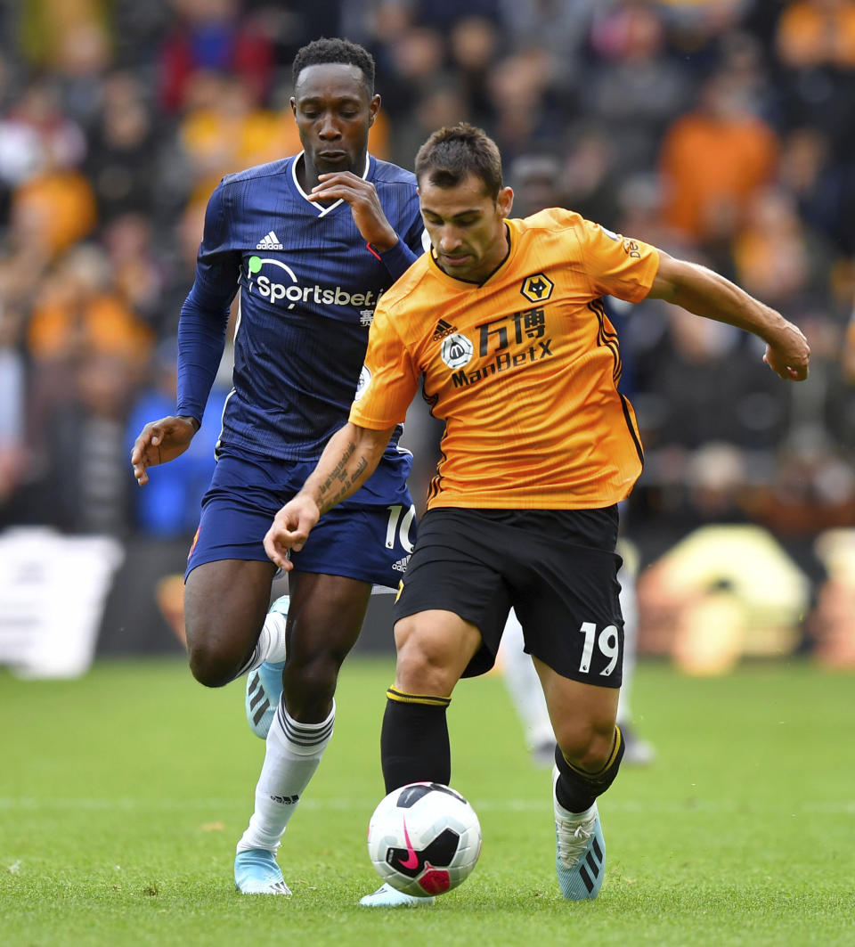 Wolverhampton Wanderers' Jonny, right, and Watford's Danny Welbeck in action during their English Premier League soccer match at Molineux Stadium in Wolverhampton, England, Saturday Sept. 28, 2019. (Dave Howarth/PA via AP)