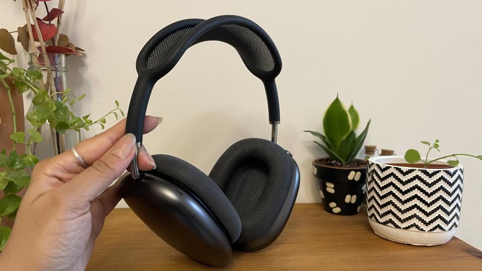 Charcoal-coloured AirPods Max in the hand