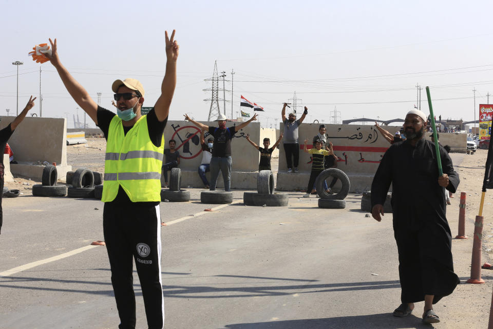 Anti-government protesters block the port of Umm Qasr a day after clashes between security forces and protesters, in Basra, Iraq, Sunday, Nov. 3, 2019. (AP Photo/Nabil al-Jourani)