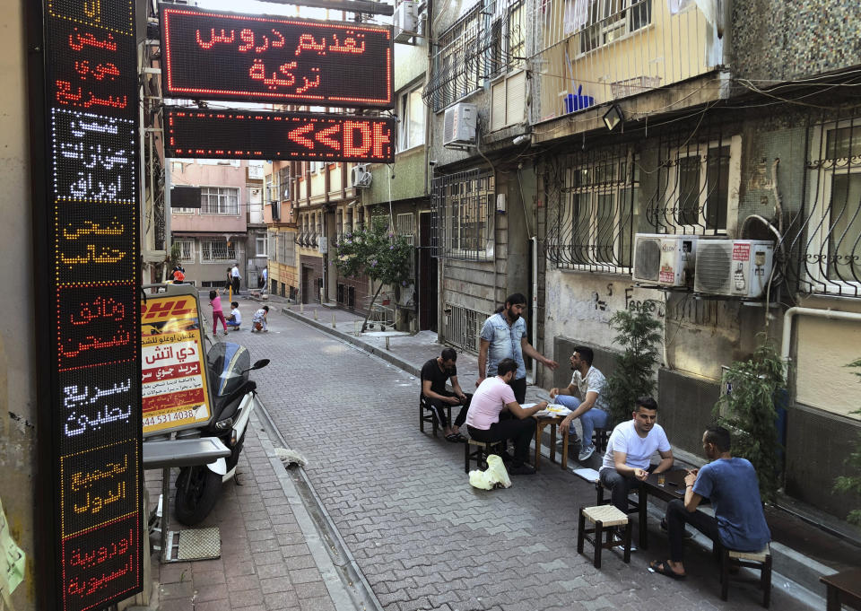 In this photo taken on July 31, 2019, Syrians pass time at a coffee shop in an Istanbul neighborhood where many Syrians live. Syrians say Turkey has been detaining and forcing some Syrian refugees to return back to their country the past month. The expulsions reflect increasing anti-refugee sentiment in Turkey, which opened its doors to millions of Syrians fleeing their country's civil war. (AP Photo/Mehmet Guzel)