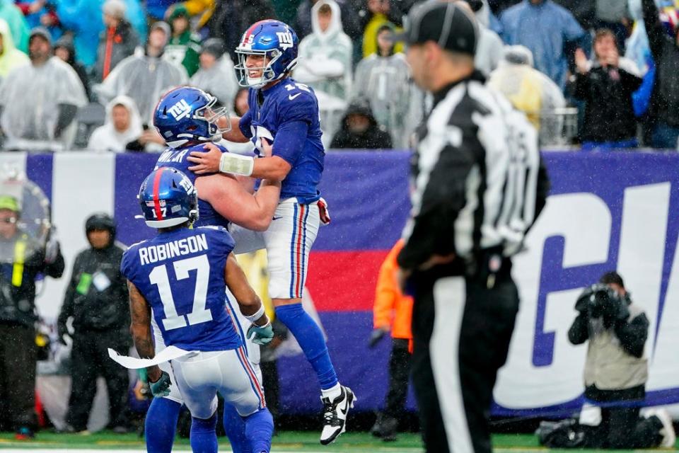 New York Giants quarterback Tommy DeVito (15) celebrates after running in a touchdown during the second half of an NFL football game against the New York Jets, Sunday, Oct. 29, 2023, in East Rutherford, N.J. (AP Photo/Frank Franklin II)