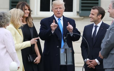 French first lady Brigitte Macron and US first lady Melania Trump listen as US President Donald Trump speaks with French President Emmanuel Macron at Mount Vernon - Credit:  LUDOVIC MARIN/AFP