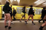 Passengers without their pants exit a subway during the "No Pants Subway Ride" at Alexanderplatz subway station in Berlin January 12, 2014. The event is an annual flash mob and occurs in different cities around the world, according to its organisers. REUTERS/Fabrizio Bensch (GERMANY - Tags: SOCIETY ENTERTAINMENT)