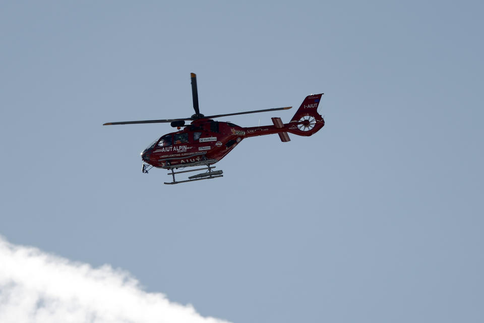 A helicopter flies to evacuate United States' Mikaela Shiffrin after she crashed during an alpine ski, women's World Cup downhill race, in Cortina d'Ampezzo, Italy, Friday, Jan. 26, 2024. Shiffrin crashed into the safety nets after losing control landing a jump during a World Cup women's downhill on Friday. (AP Photo/Gabriele Facciotti)