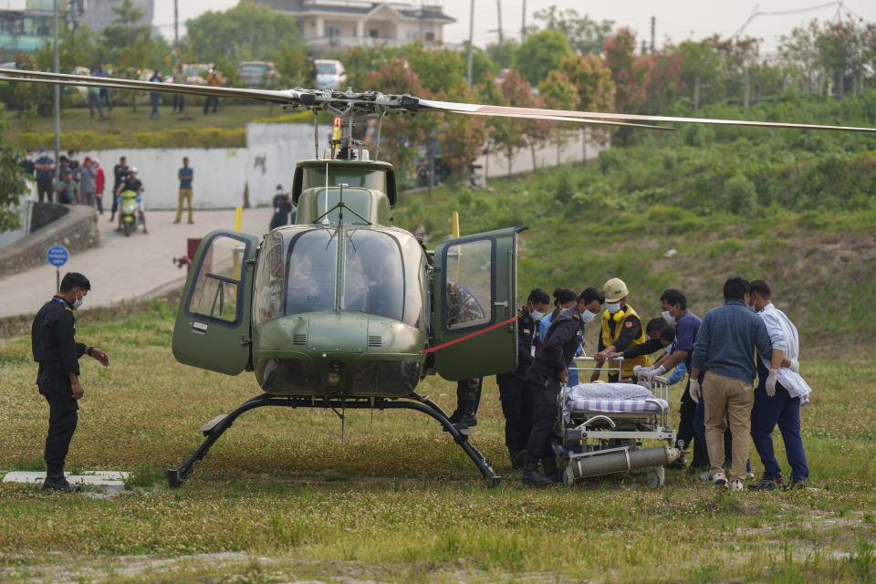 Hospital staff get ready to evacuate as a helicopter carrying injured Indian climber Anurag Maloo who was rescued from Annapurna region lands at Medicity hospital in Kathmandu, Nepal, Thursday, April 20, 2023. The Indian climber who fell into a 300-meter (980-foot) crevasse on Mount Annapurna on Monday was rescued Thursday. (AP Photo/Niranjan Shrestha)