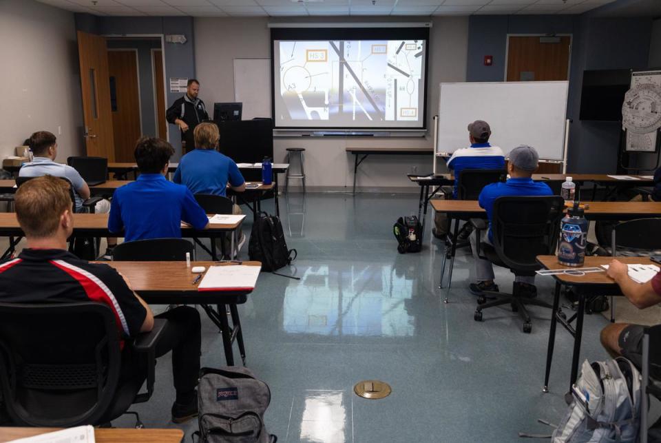 Students training to become pilots sit in class and watch a video about navigating runway terminology at the Texas State Technical College in Waco on Oct. 24, 2022.