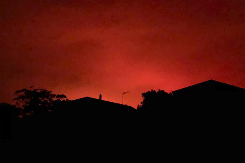 This Tuesday, Dec. 31, 2019, photo provided by Twitter user @AvaTheHuman shows red sky from wildfires burning, in Victoria, Australia. On Tuesday morning, 4,000 people in the coastal town of Mallacoota fled to the shore as winds pushed a fire toward their homes under a sky darkened by smoke and turned blood-red by flames. (@AvaTheHuman via AP)