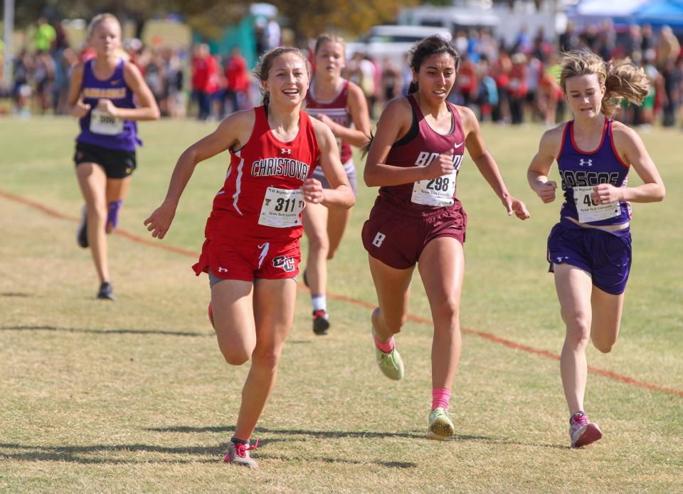 Christoval's Madyson George (left) sprints past Bovina's Faith Gonzales and Roscoe's Zoey Welch in the Region I-2A cross country meet on Monday, Oct. 24, 2022 at Mae Simmons Park.