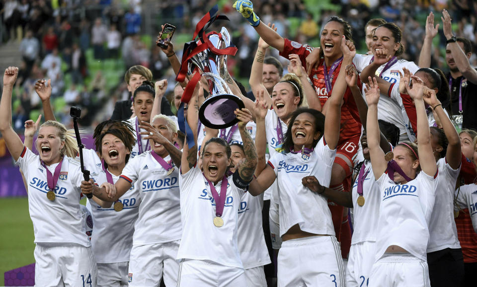 Olympique Lyon players celebrate with the trophy after the women's soccer Champions League final match between Olympique Lyon and FC Barcelona at the Groupama Arena in Budapest, Hungary, Saturday, May 18, 2019. Lyon defeated Barcelona by 4-1. (Balazs Czagany/MTI via AP)