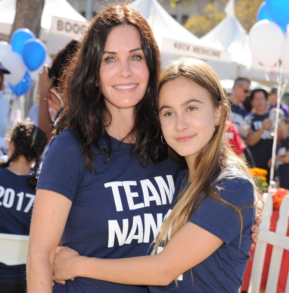 Coco Arquette giving Courteney Cox a hug