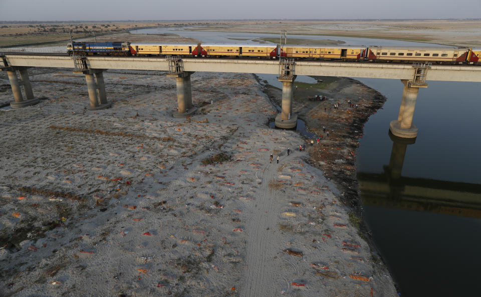 Bodies are seen in shallow graves on the banks of the Ganges River. 