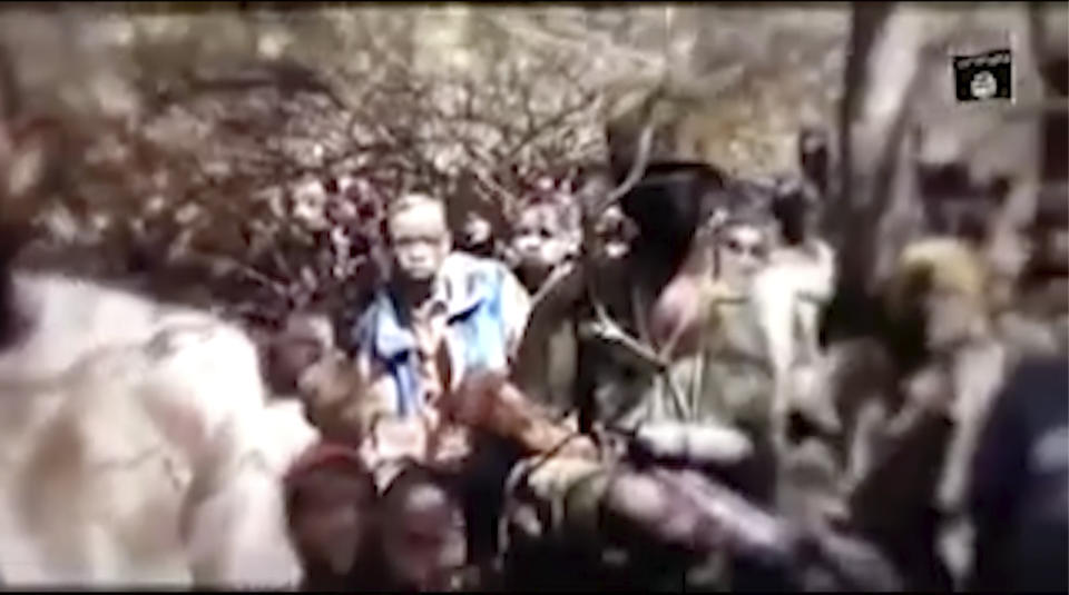 In this image made from an undated video provided by Boko Haram, boys are seen in an undisclosed location. A video allegedly released on Thursday, Dec. 17 2020 by Nigeria's jihadist rebels, Boko Haram, shows a group of boys under trees, speaking to a person filming them. Last week more than 300 students were kidnapped from a school in Kankara, in the north of the country, the children in the video are supposed to be those abducted last Friday. (Boko Haram/Militant Video via AP)