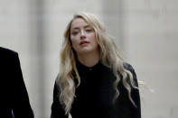 American actress Amber Heard arrives at the High Court in London, Tuesday, July 28, 2020. Hollywood actor Johnny Depp is suing News Group Newspapers over a story about his former wife Amber Heard, published in The Sun in 2018 which branded him a 'wife beater', a claim he denies.(AP Photo/Matt Dunham)