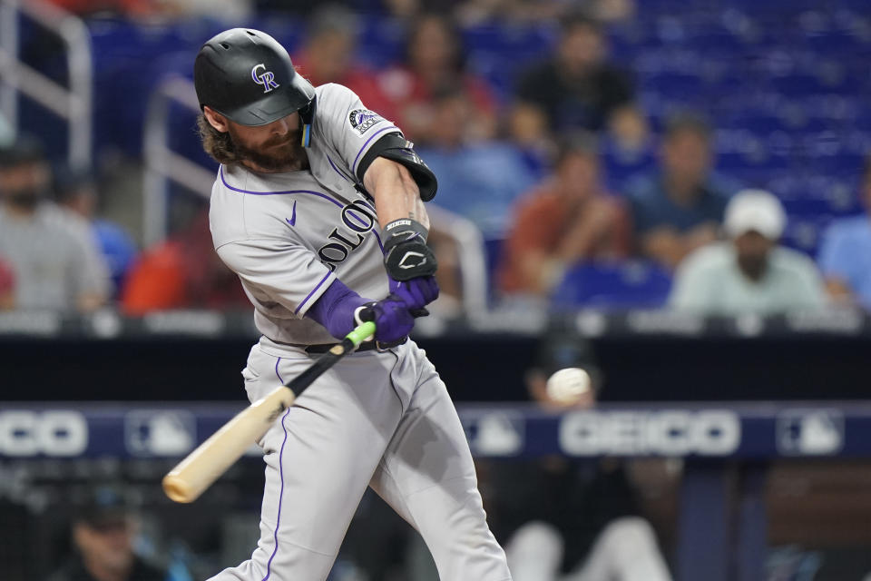 Colorado Rockies' Brendan Rodgers hits a double scoring C.J. Cron during the third inning of a baseball game against the Miami Marlins, Thursday, June 23, 2022, in Miami. (AP Photo/Wilfredo Lee)