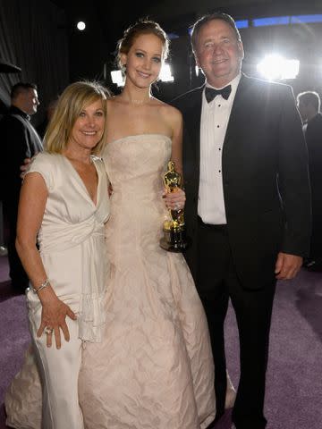 <p>Kevork Djansezian/Getty</p> Jennifer Lawrence, Karen Lawrence and Gary Lawrence attend the 2013 Oscars Governors Ball.