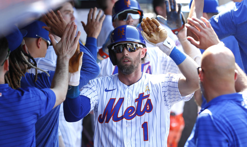 New York Mets' Jeff McNeil (1) celebrates in the dugout after scoring against the Seattle Mariners during the third inning of a baseball game, Sunday, Sept. 3, 2023 in New York. (AP Photo/Noah K. Murray)