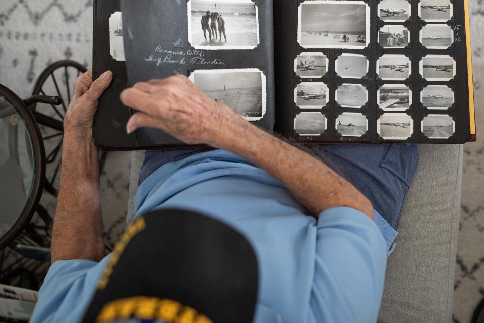 Harold Barcus reminisces on his time serving in the Korean War while looking at old photographs on Wednesday, April 10, 2024.