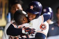 Jun 20, 2018; Houston, TX, USA; Houston Astros center fielder George Springer (4) celebrates with second baseman Tony Kemp (18) in the dugout after hitting a home run during the sixth inning against the Tampa Bay Rays at Minute Maid Park. Mandatory Credit: Shanna Lockwood-USA TODAY Sports