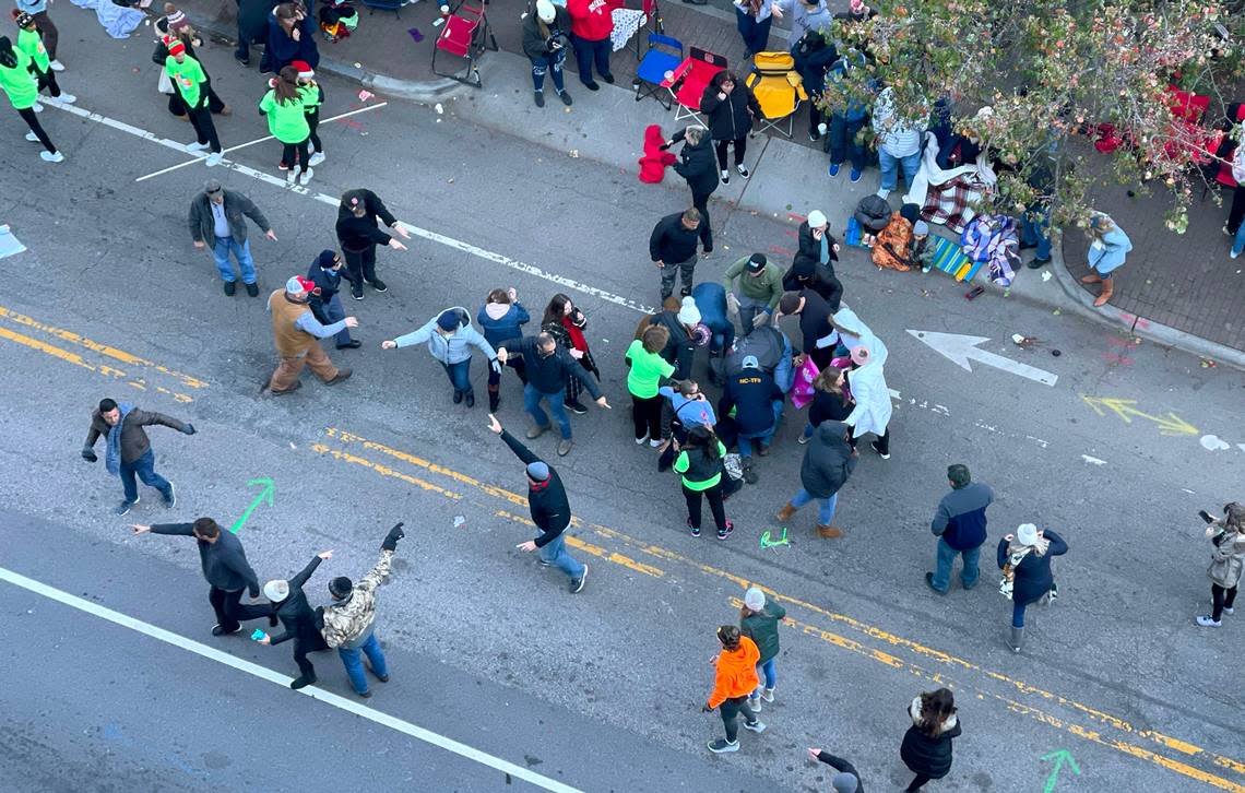 Personnel rush to where a person was injured during the Raleigh Christmas Parade on Hillsborough Street in Raleigh, N.C., Saturday, Nov. 19, 2022.