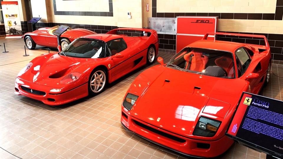 a group of red cars parked in a room