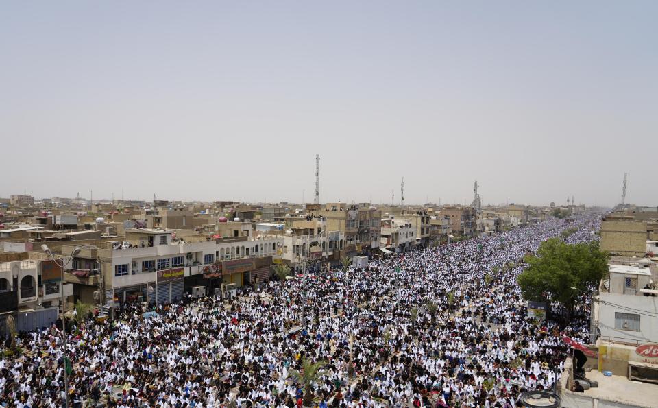 Followers of Shiite cleric Muqtada al-Sadr chant slogans during an open-air Friday prayers in Sadr City, Baghdad, Iraq, Friday, July 15, 2022. (AP Photo/Hadi Mizban)