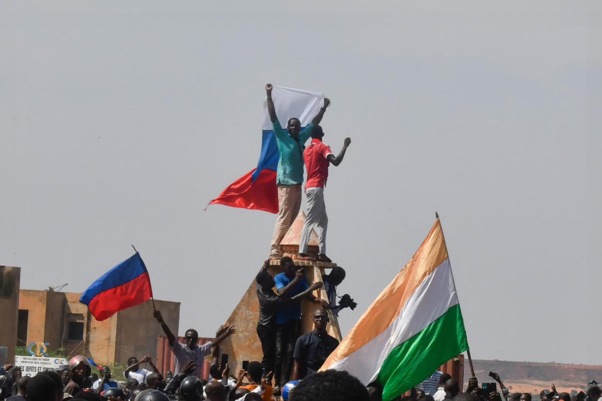 Protesters wave Nigerien and Russian flags AFP via Getty Images