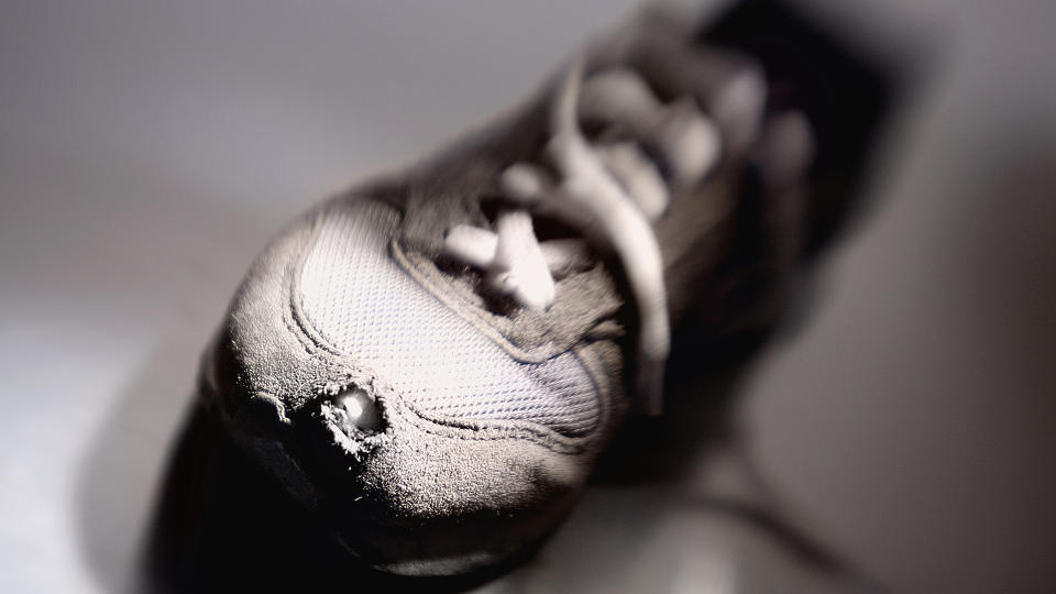 A running shoe with a hole in the toe