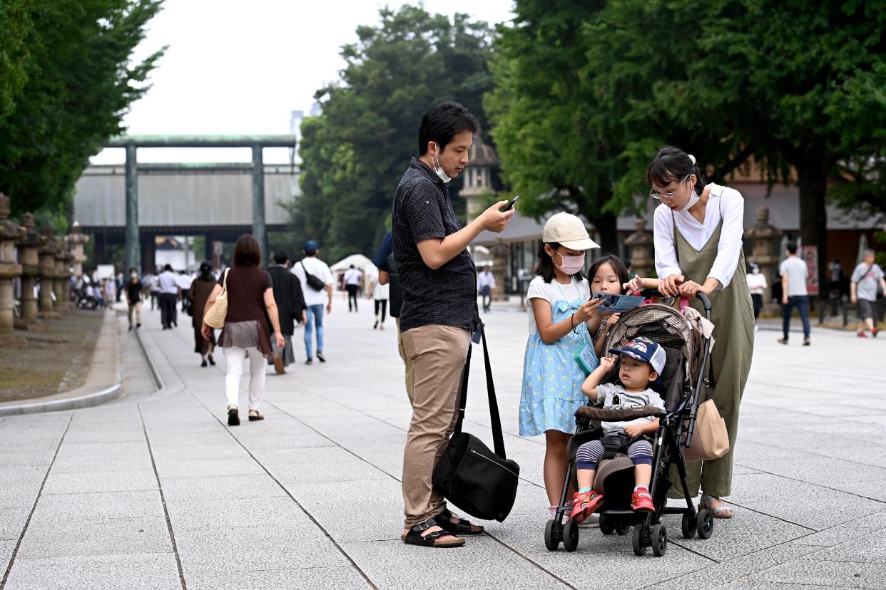 A family visits the Yasukuni Shrine in Tokyo on August 15, 2022.