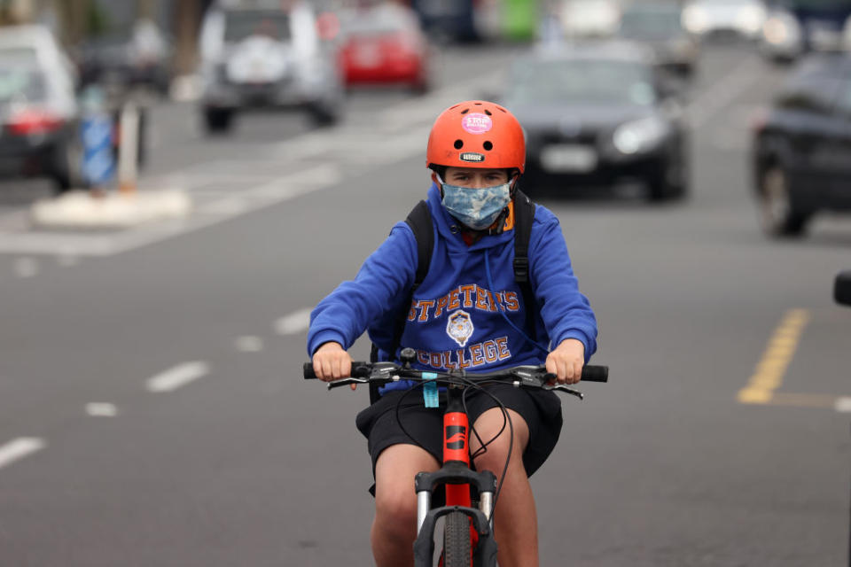 A boy rides his bike along Ponsonby Road in Auckland, New Zealand.