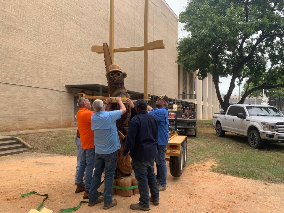 Clyde Kilpatrick, Richard Sistrunk, Ephraim Calhoun and Joseph Shumate load the new bear sculpture onto a truck on Oct. 13 in Jackson carved by Dayton Scoggins to take it to Rolling Fork in preparation for the 2023 Great Delta Bear Affair.