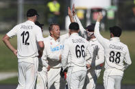 New Zealand's Neil Wagner, center left, celebrates Bangladesh's Najmul Hossain Shanto being caught with teammates on day two of the first cricket test between Bangladesh and New Zealand at Bay Oval in Mount Maunganui, New Zealand, Sunday, Jan. 2, 2022. (Marty Melville/Photosport via AP)