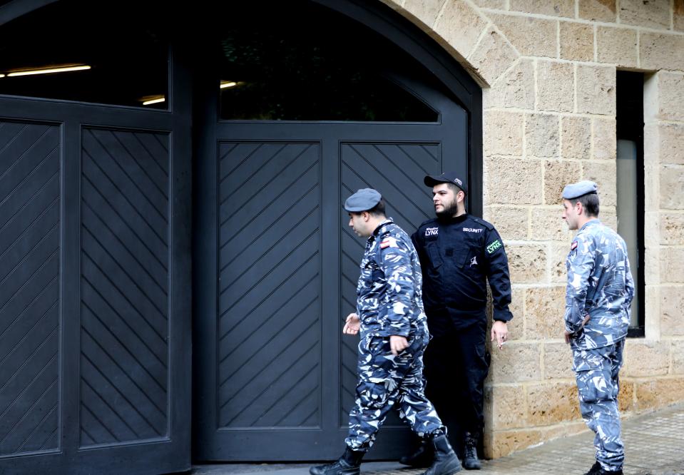 Members of Lebanon's security forces stand at the parking gate of the house identified by court documents as belonging to former Nissan chief Carlos Ghosn in a wealthy neighbourhood of the Lebanese capital Beirut on December 31, 2019. - Ghosn said today he had fled to Lebanon to escape injustice in Japan, where he was on bail awaiting trial on financial misconduct charges. The auto tycoon's abrupt departure was the latest twist in a rollercoaster journey that saw him fall from boardroom to detention centre and it sparked questions over an embarrassing security lapse in Japan. Ghosn, 65, stands accused of two counts of under-reporting his salary to the tune of 9.23 billion yen ($85 million) from 2010 to 2018, deferring some of his pay and failing to declare this to shareholders. (Photo by ANWAR AMRO / AFP) (Photo by ANWAR AMRO/AFP via Getty Images)