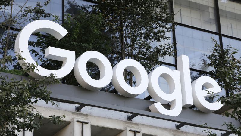 A Google sign hangs over an entrance to the company’s new building, Sept. 6, 2023, in New York. Google has agreed to pay $700 million and make several other concessions to settle allegations that it had been stifling competition against its Android app store — the same issue that went to trial in another case that could result in even bigger changes.