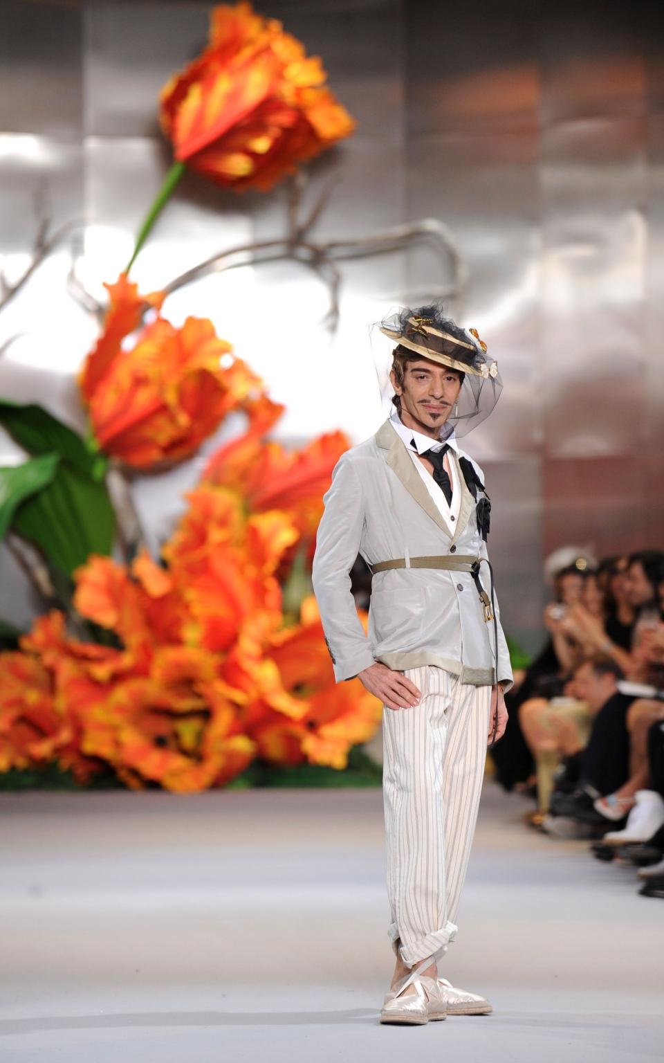 Designer John Galliano walks the runway at the end of the Dior show in Paris, 2010