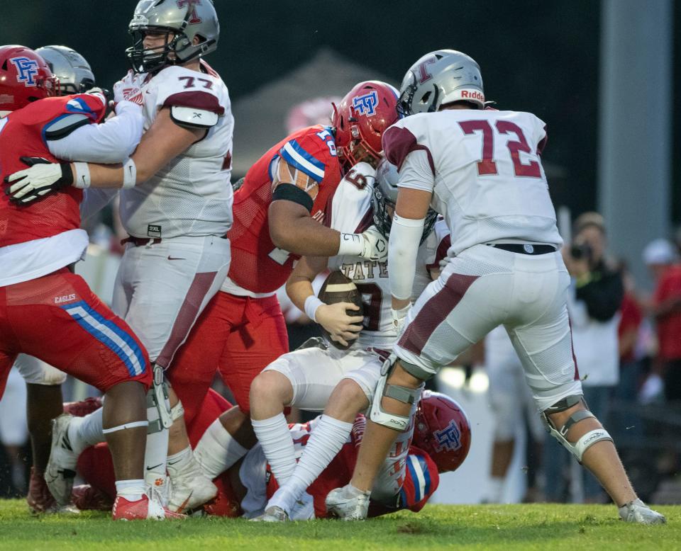 Rocsavian McWilliams (99) and Elijah Douglas (10) sack quarterback Taite Davis (9) during the Tate vs Pine Forest football game at Pine Forest High School in Pensacola on Thursday, Aug. 25, 2022.