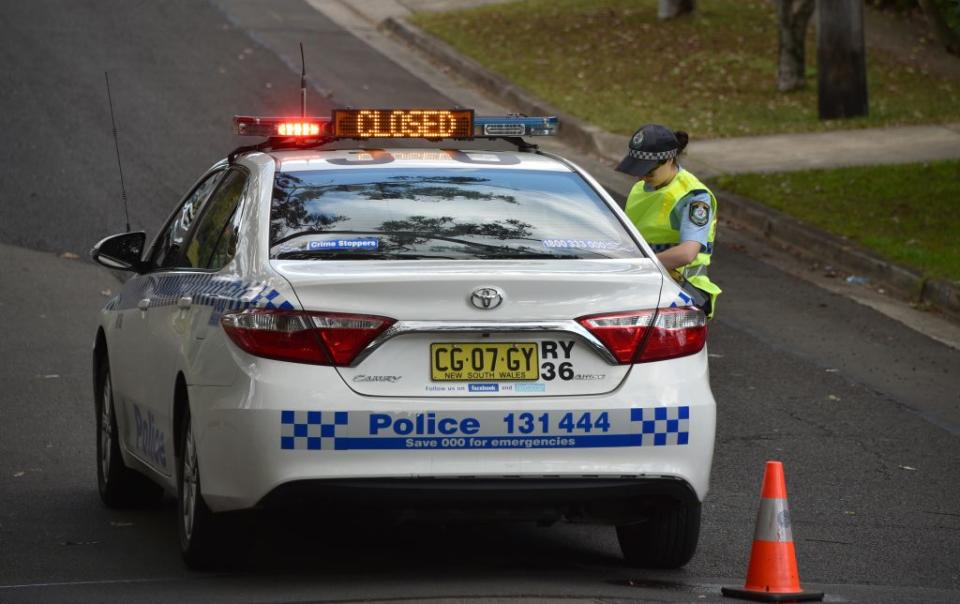 A policewoman standing next to a police car in Sydney on July 6, 2018.