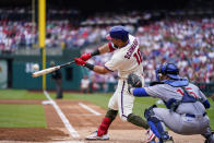 Philadelphia Phillies' Kyle Schwarber, left, hits a grand slam off of Chicago Cubs' Jameson Taillon (not shown) during the first inning of a baseball game, Saturday, May 20, 2023, in Philadelphia. (AP Photo/Matt Rourke)