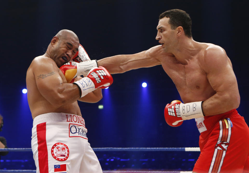 IBF, WBA, WBO and IBO champion Wladimir Klitschko from Ukraine, right, punches his Australian challenger Alex Leapai during their heavyweight world title bout in Oberhausen, western Germany, Saturday, April 26, 2014. (AP Photo/Frank Augstein)