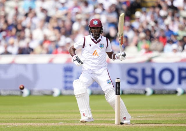 Kraigg Brathwaite raises his bat after scoring a fifty on day one at Edgbaston